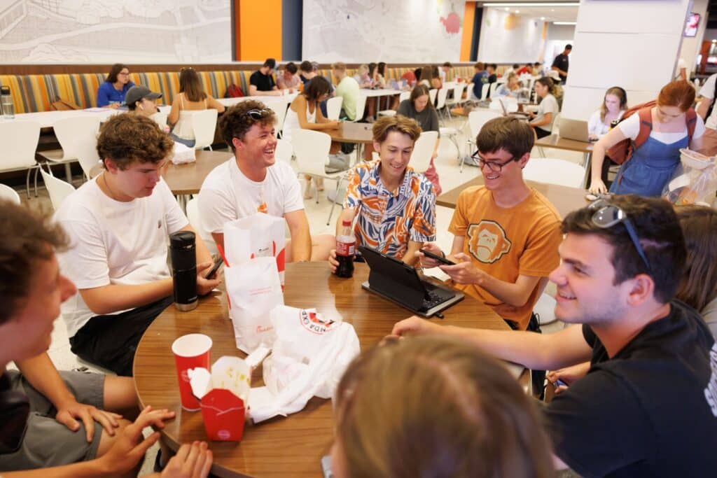 students gathered at a table in a ut dining hall